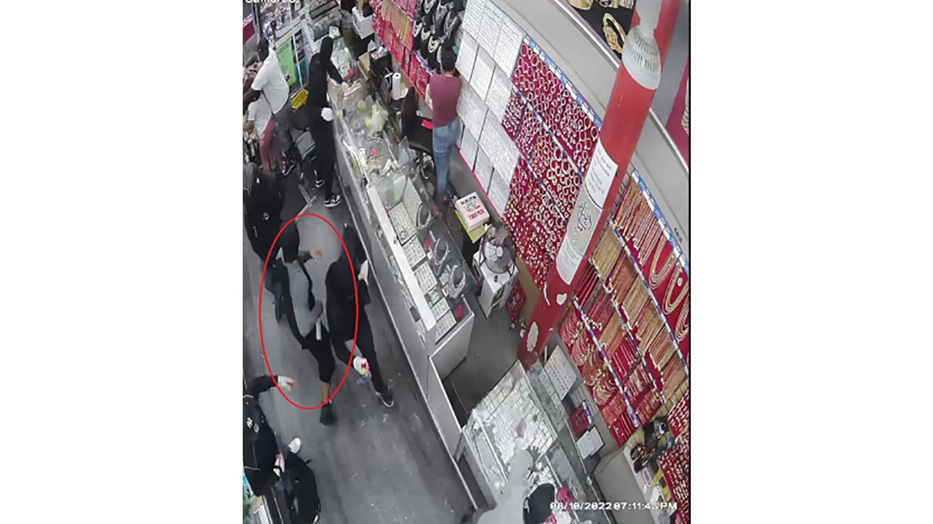 Surveillance footage of bear spray robbery