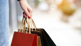 Stock image of hand holding shopping bags