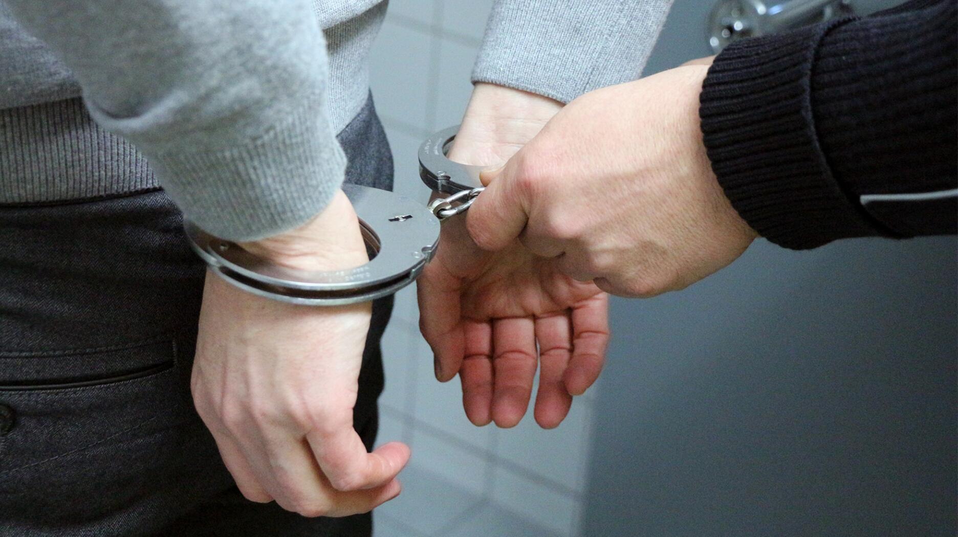 Stock photo of a suspect in handcuffs 